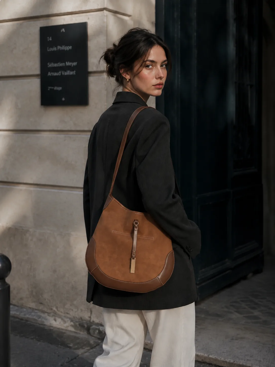 Mira Curve Tote worn over a dark jacket