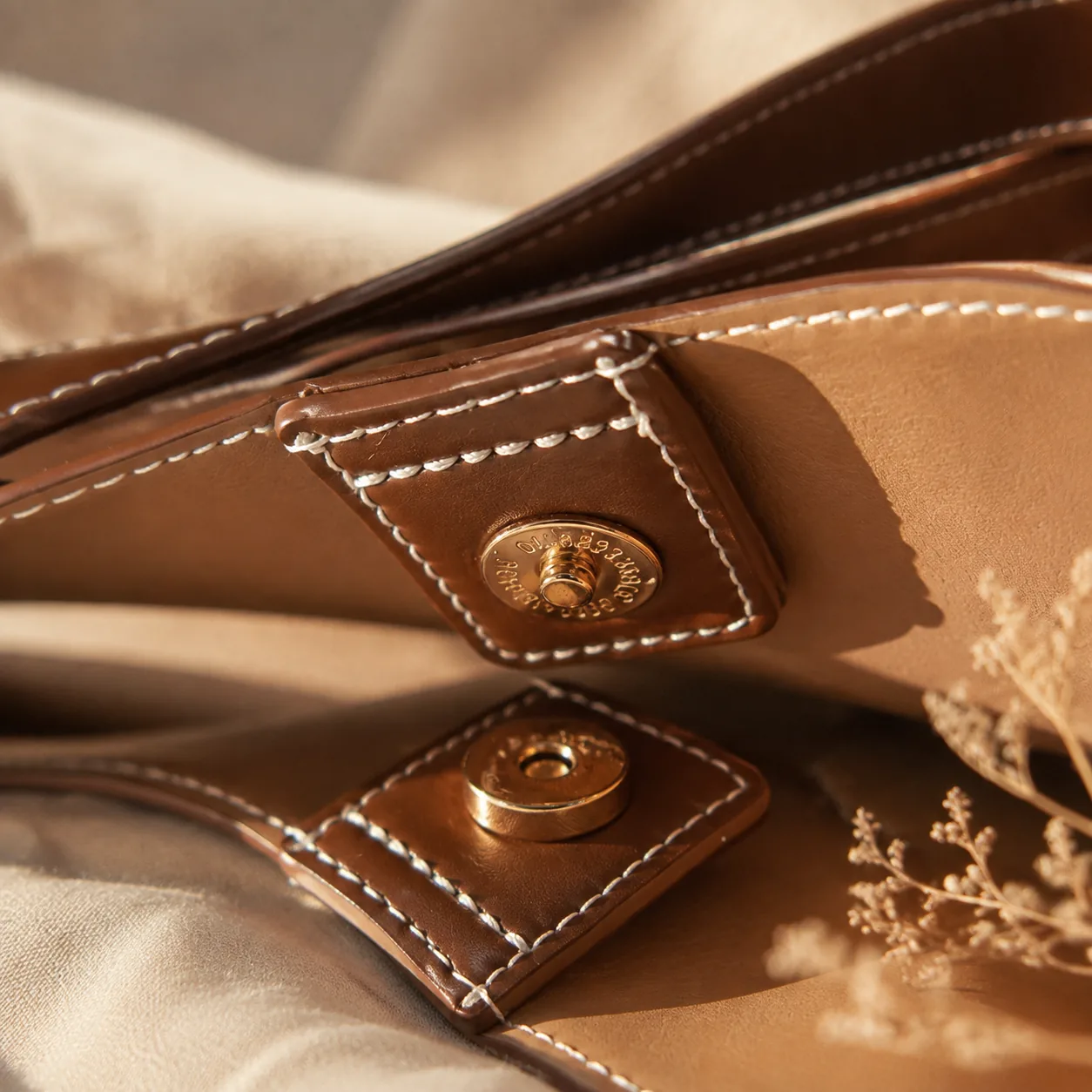 Close-up of the gold-tone magnetic closure inside the bag