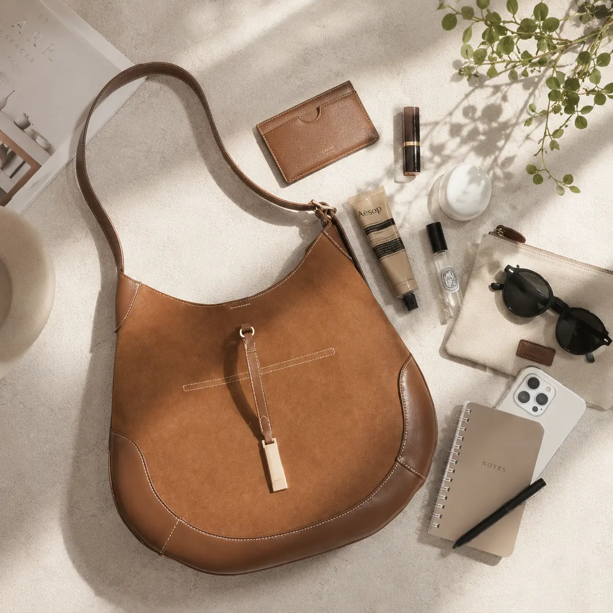 Flat-lay of Mira Curve Tote with everyday essentials