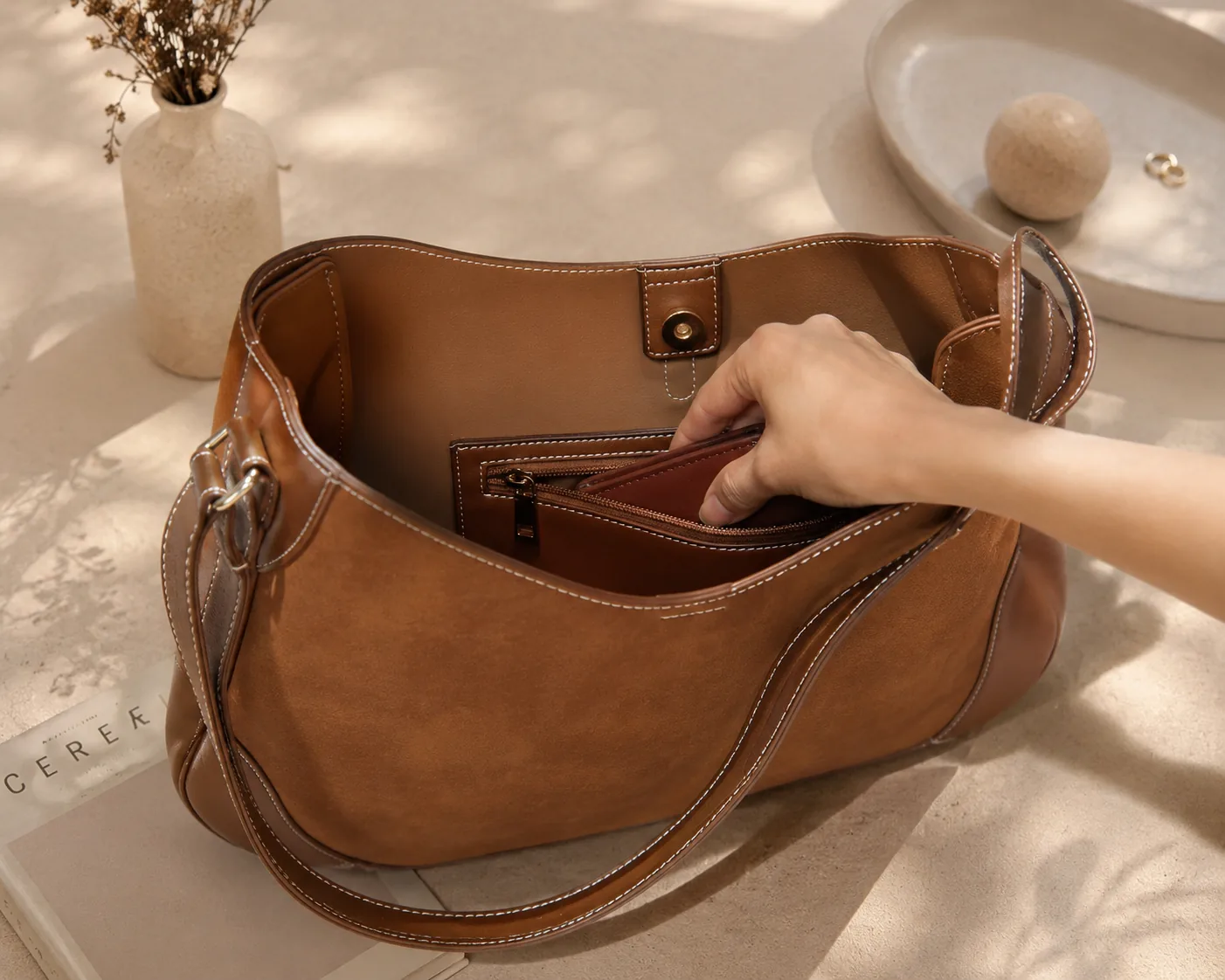 A hand reaching into the interior pocket for a wallet