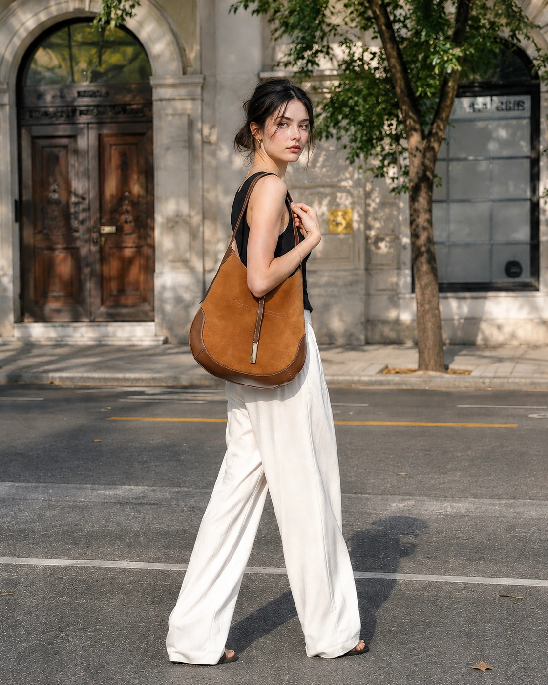 Mira Curve Tote - suede-like brown tote resting on the shoulder with an adjustable leather-look strap